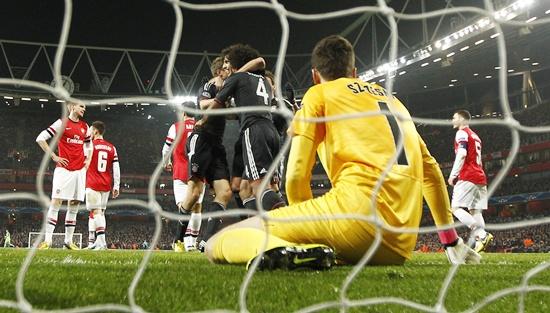 Bayern Munich's Thomas Muller (centre) celebrates with teammates after scoring past Arsenal's goalkeeper Wojciech Szczesny (right)