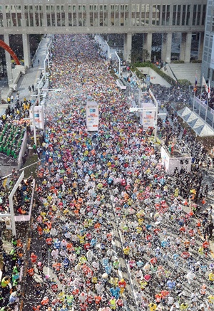 Runners fill the street at the start of the Tokyo Marathon