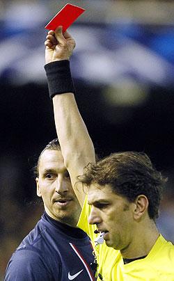 Paris Saint Germain's Zlatan Ibrahimovic (L) reacts as he is shown a red card