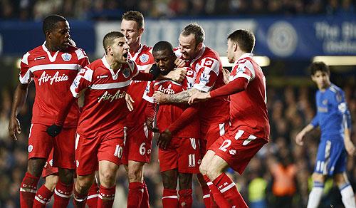 Queens Park Rangers' Shaun Wright-Phillips (centre) is mobbed by teammates after scoring against Chelsea during their English Premier League match on Wednesday