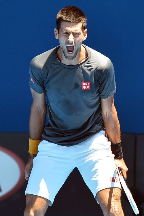 Novak Djokovic of Serbia reacts after hitting a winner during his practice session ahead of the 2013 Australian Open at Melbourne Park