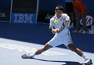 Novak Djokovic of Serbia hits a return to Paul-Henri Mathieu of France on Monday