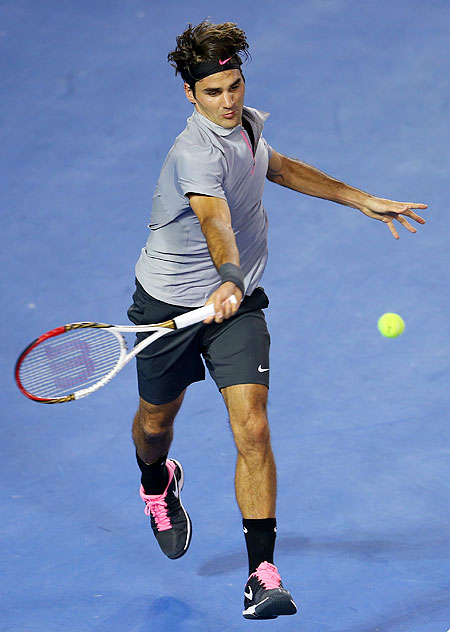 Roger Federer plays a forehand in his second round match against Nikolay Davydenko