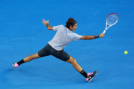 Roger Federer plays a backhand in his second round match against Nikolay Davydenko on Thursday