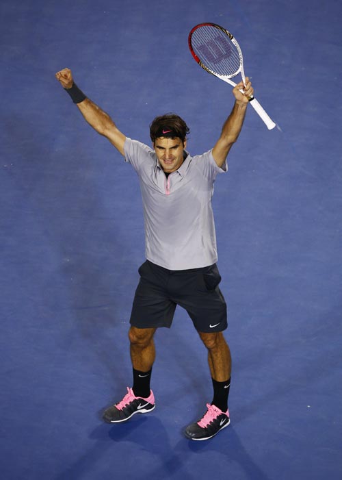 Roger Federer of Switzerland celebrates defeating Jo-Wilfried Tsonga of France in their men's singles quarter-final match