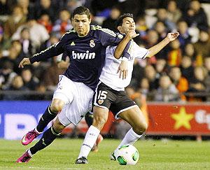 Real Madrid's Cristiano Ronaldo (left) and Valencia's Joanathan Viera vie for the ball during their King's Cup quarter-final second leg match at the Mestalla stadium in Valencia, on Wednesday