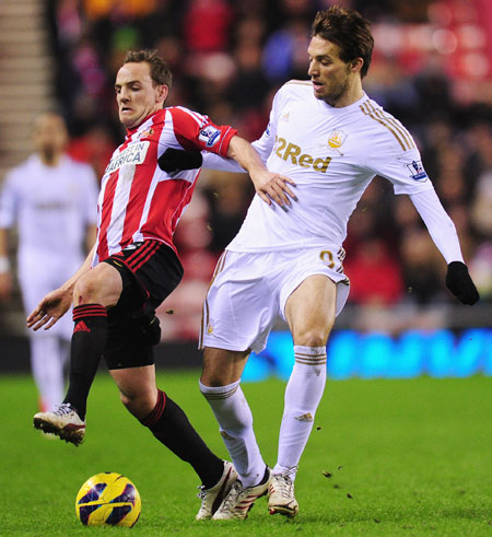 Swansea City player Michu (right) is challenged by Sunderland player David Vaughan during the Premier League match at Stadium of Light