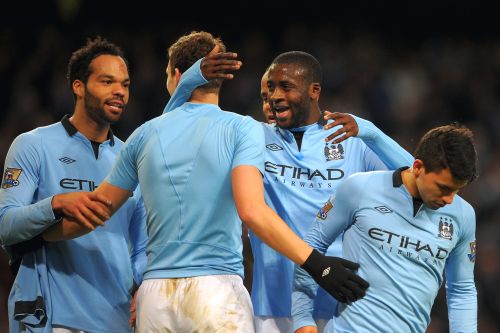 Manchester City players celebrate after scoring