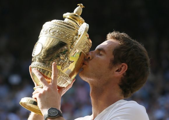 Andy Murray of Britain kisses the winners trophy after defeating Novak Djokovic of Serbia in their men's singles final tennis match at the Wimbledon Tennis Championships