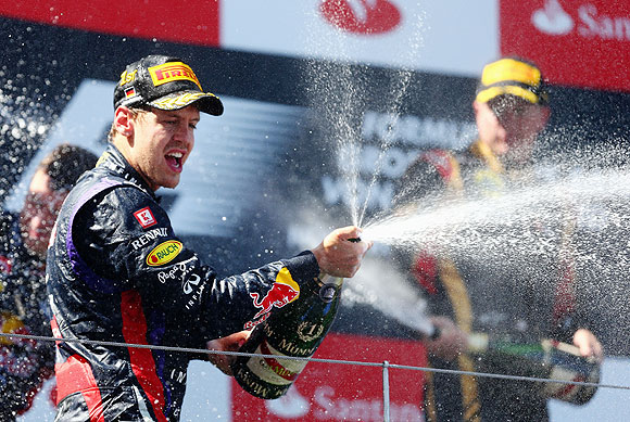 Sebastian Vettel of Germany and Infiniti Red Bull Racing celebrates on the podium after winning the German Grand Prix at the Nuerburgring on Sunday