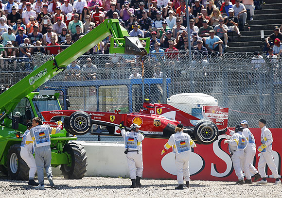 The car of Ferrari Formula One driver Felipe Massa of Brazil is removed from the track during the German F1 Grand Prix on Sunday