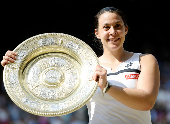  Marion Bartoli of France poses with the Venus Rosewater Dish trophy after her victory against Sabine Lisicki of Germany