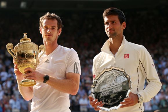 Andy Murray of Great Britain poses with the Gentlemen's Singles Trophy next to Novak Djokovic of Serbia following his victory in the Gentlemen's Singles Final match