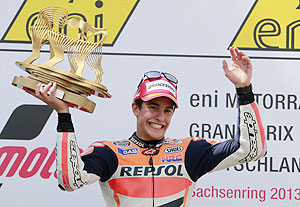 Repsol Honda MotoGP rider Marc Marquez of Spain lifts the trophy after winning the German Grand Prix at the Sachsenring circuit, near the eastern German town of Hohenstein-Ernsthal on Sunday