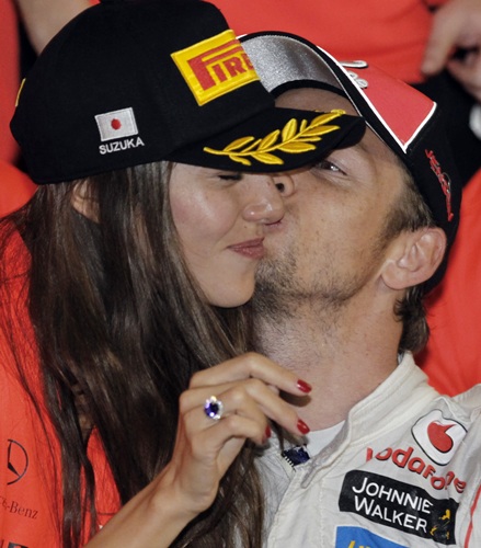 McLaren Formula One driver Jenson Button of Britain kisses his girlfriend, Japanese-Argentine model Jessica Michibata