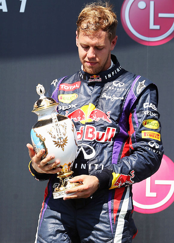 Sebastian Vettel of Germany and Infiniti Red Bull Racing celebrates on the podium after finishing third during the Hungarian Formula One Grand Prix at Hungaroring in Budapest, Hungary, on Sunday
