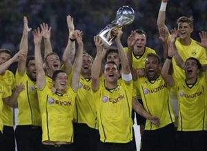 Borussia Dortmund's Sebastian Kehl lifts the German Super Cup trophy