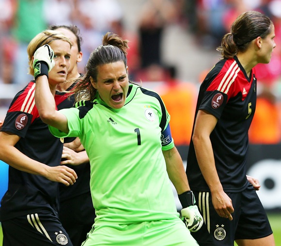 Nadine Angerer (centre), goalkeeper of Germany celebrates after she saves the penalty