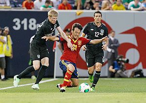 Spain's David Silva battles for the ball with Ireland's Andy Keogh and Stephen Kelly during an international friendly at Yankee Stadium on Tuesday