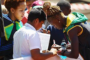 Dominique Blake of Jamaica signs autographs during a training session