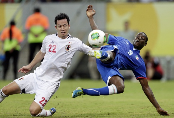 Italy's Mario Balotelli (right) attempts to score as Japan's Maya Yoshida challenges