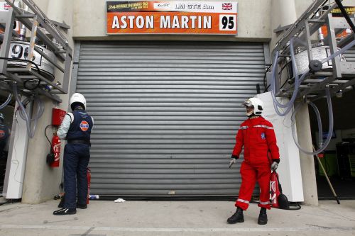 A race steward stands in front of the pit lane of Aston Martin number 95 during the Le Mans 24-hour sportscar race in Le Mans