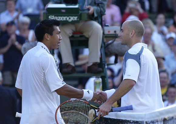 Paradorn Srichaphan of Thailand is congratulated by Andre Agassi of the USA