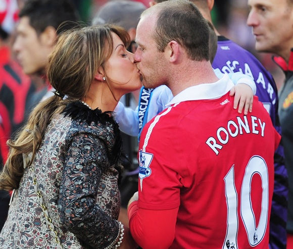 Manchester United football player Wayne Rooney and his wife Coleen watch