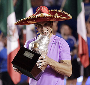 Rafael Nadal celebrates witb the trophy after winning the Mexican Open on Sunday