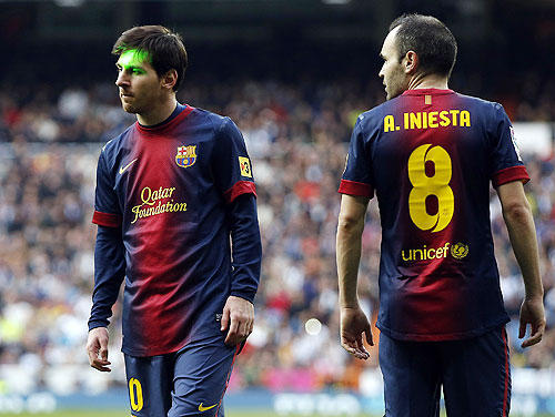 Barcelona's Lionel Messi (left) and team-mate Andres Iniesta during their La Liga  'Clasico' match against Real Madrid at the Santiago Bernabeu stadium on Saturday