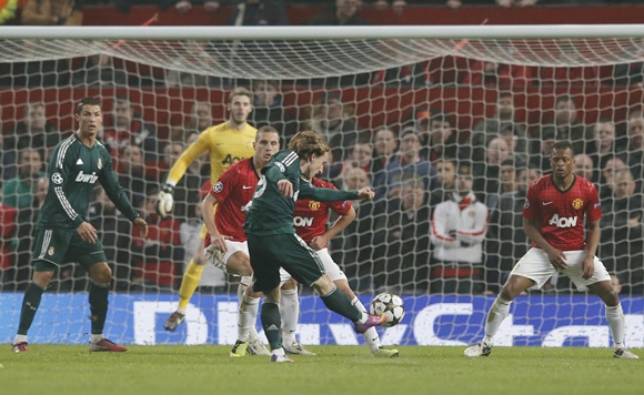 Real Madrid's Luka Modric (centre) scores against Manchester United
