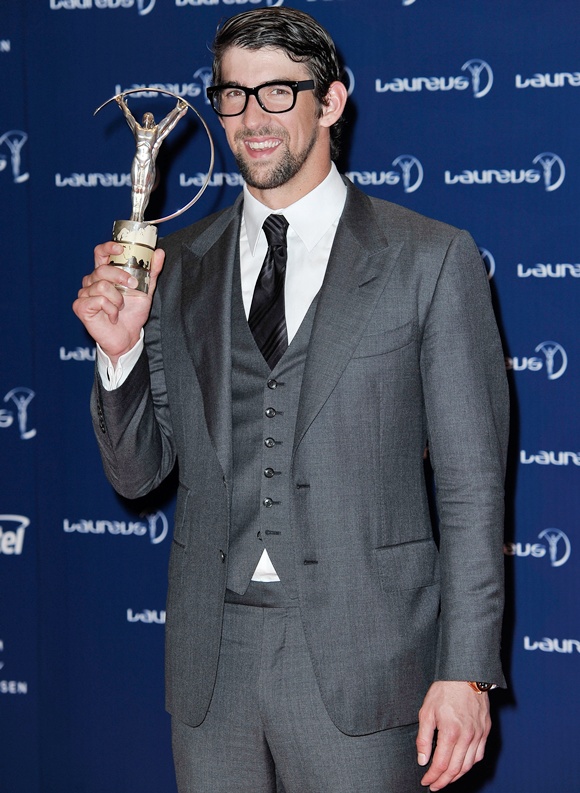 Michael Phelps poses with his award