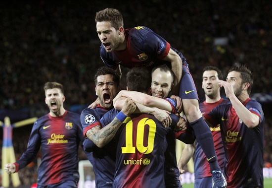 Barcelona's Lionel Messi (10) is congratulated by   team mates Dani Alves (left), Jordi Alba (top) and Andres Iniesta