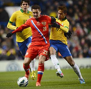 Brazil's Neymar (right) and Victor Fayzulin of Russia vie for the ball during their friendly at Stamford Bridge in London on Monday