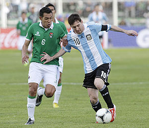 Argentina's Lionel Messi (right) and Bolivia's Walter Veizaga vie for possession during their 2014 World Cup qualifying match in La Paz on Tuesday