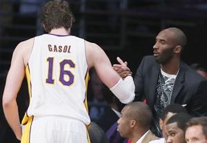 Los Angeles Lakers Pau Gasol of Spain (left) shakes hands with injured guard Kobe Bryant