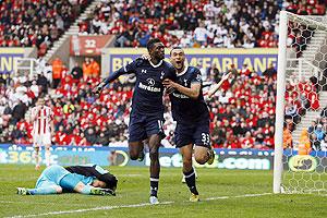 Tottenham Hotspur's Emmanuel Adebayor (centre) celebrates with teammate Steven Caulker after scoring against Stoke City during their English Premier League match at the Britannia Stadium in Stoke-on-Trent, England on Sunday