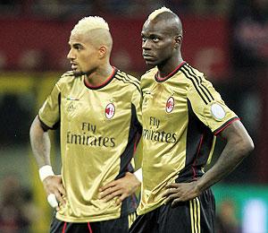 AC Milan's Kevin-Prince Boateng (left) and Mario Balotelli look on as referee Gianluca Rocchi suspends the match due to racist chants during their Italian Serie A soccer match against AS Roma at the San Siro stadium in Milan on Sunday