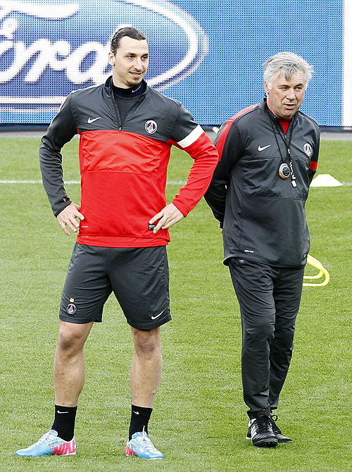 Paris St Germain's coach Carlo Ancelotti (right) and Zlatan Ibrahimovic attend a training session