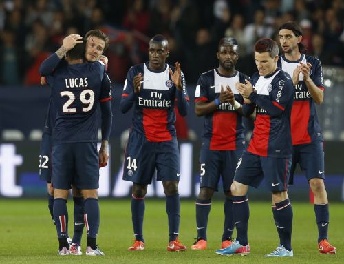 Paris Saint-Germain's David Beckham (facing camera, on 2nd L) hugs team-mates and breaks down in tears after he is substituted in the 81st minute