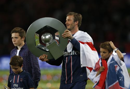 Paris Saint-Germain's David Beckham raises the French Championship trophy at the end of their team's French Ligue 1 soccer match