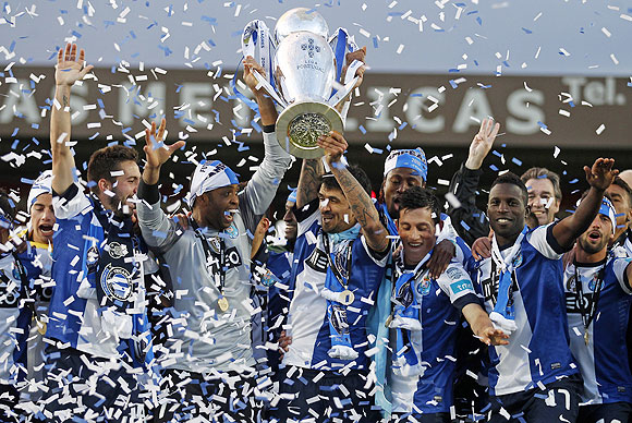 Porto's goalkeeper Helton Arruda (left) and captain Lucho Gonzalez celebrate their Portuguese Premier League title win with teammates on Sunday