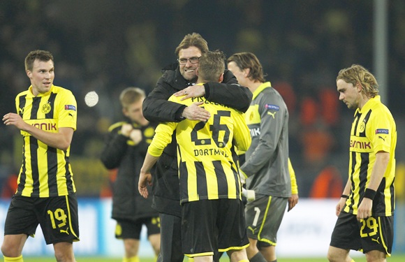 Borussia Dortmund's coach Juergen Klopp hugs his players