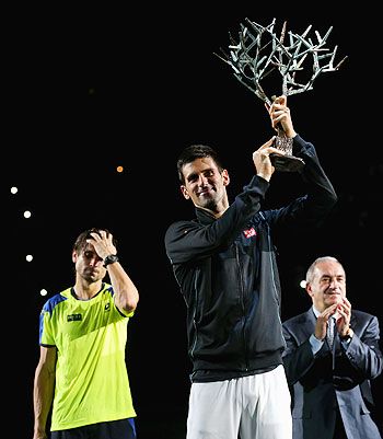 Novak Djokovic of Serbia with the winners trophy after defeating David Ferrer of Spain in the final of the Paria Masters on Sunday