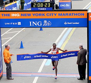 Geoffrey Mutai of Kenya crosses the finish line in Central Park to win the 2013 ING New York City Marathon on November 3