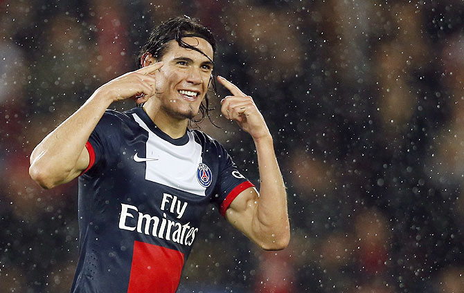 Paris St Germain's Edinson Cavani celebrates after he scored against FC Lorient in their French Ligue 1 soccer match at the Parc des Princes Stadium in Paris on Friday