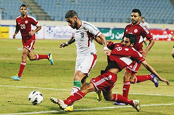 Lebanon's Ali Hamam (R) fights for the ball with Iran's Ashkan Dejagah during their AFC Asian Cup 2015 qualifying soccer match in Beirut on Tuesday
