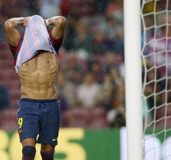 Barcelona's Alexis Sanchez reacts after missing a goal