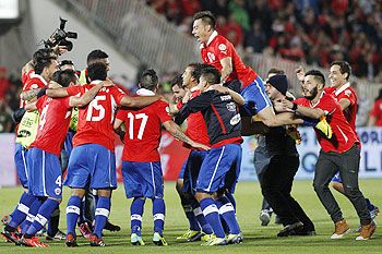 Players of Chile celebrate after defeating Ecuador to qualify for the 2014 World Cup
