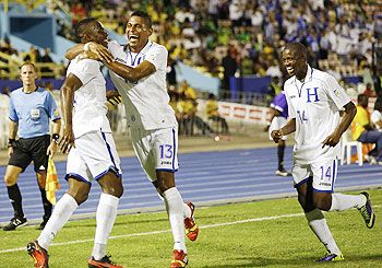 Honduras' Maynor Figueroa (left) celebrates with teammates Carlos Costly (centre) and Garcia Oscar after scoring the team's second goal against Jamaica